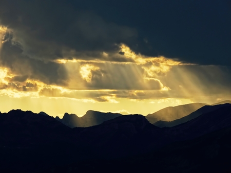 Sunbeams through the clouds on mountainの写真素材