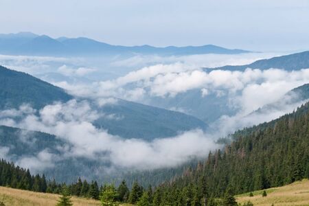 Mountain landscape with a clouds in a valleyの写真素材