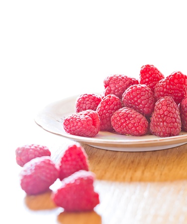 Fresh raspberries in a plate on the table