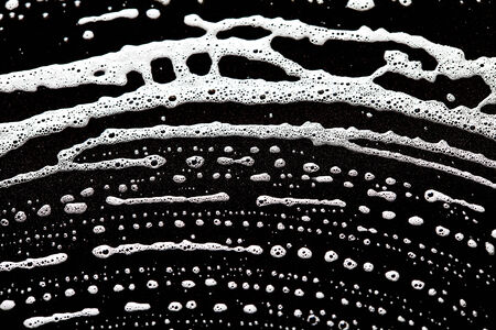 Foam bubbles abstract dark backgroundの写真素材