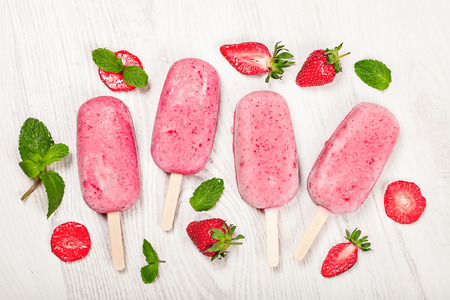 Strawberry popslice icecream on light wooden backgroundの写真素材
