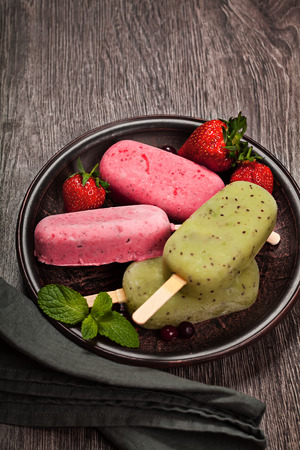 Popslices icecream  assortment on dark wooden backgroundの写真素材
