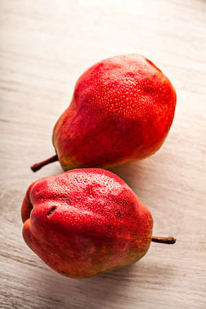Fresh juicy red pears on white wooden tableの写真素材