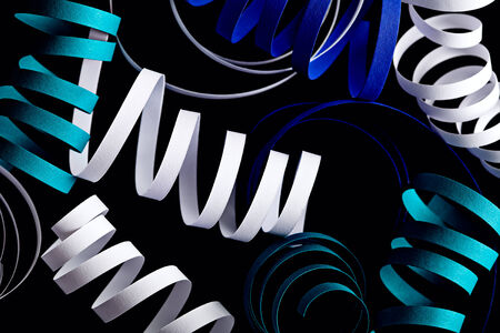 Curl blue ribbon isolated on black abstract backgroundの写真素材