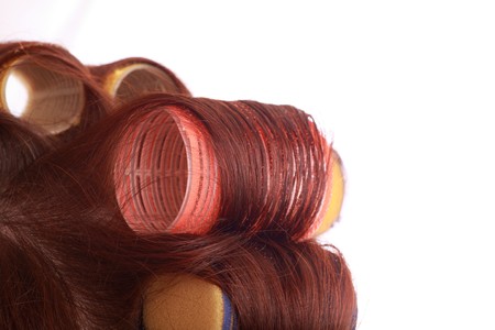 close-up of curlers in hair isolated on whiteの写真素材