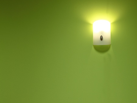 Wall lamp on the green backgroundの写真素材