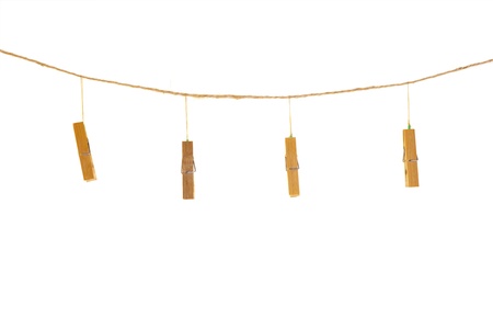 clothespins on rope isolated on whiteの写真素材