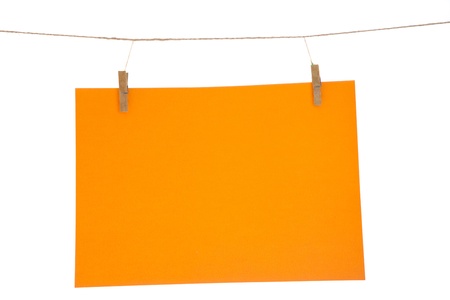 Orange blank paper sheet on a clothes line. Isolated on white background. の写真素材
