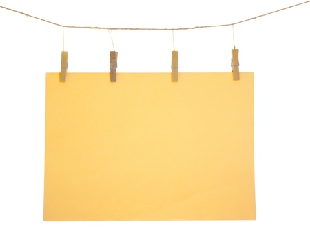 Orange blank paper sheet on a clothes line. Isolated on white background. の写真素材
