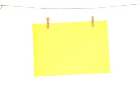 Yellow blank paper sheet on a clothes line. Isolated on white background. 