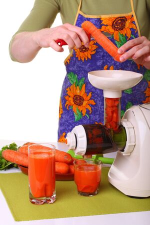 Woman Juice extractor and carrot isolated white kitchen prepareの写真素材