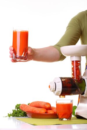 Woman Juice extractor and carrot isolated white kitchen prepareの写真素材