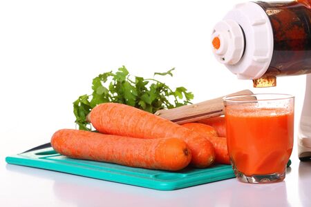 Juice extractor and carrot isolated white kitchen prepareの写真素材