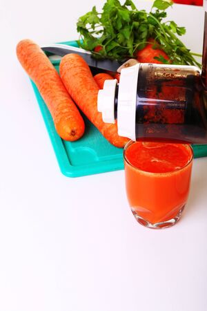 Juice extractor and carrot isolated white kitchen prepareの写真素材