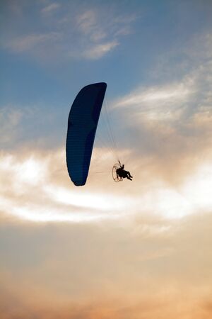 Paraglider - Feeling free on the sunset skyの写真素材