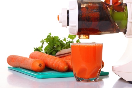 Juice extractor and carrot isolated white kitchen prepareの写真素材