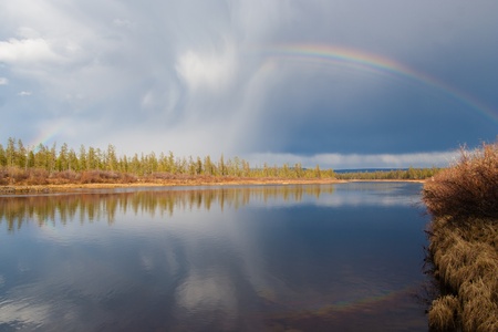 Rainbow on the river in the summer in Yakutiaの写真素材