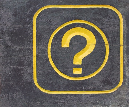 Yellow symbol of question mark on woodの写真素材