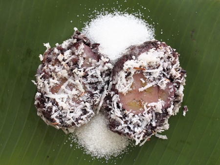 Thai style dessert, steam black glutinous rice wrap up cultivated bananaの写真素材