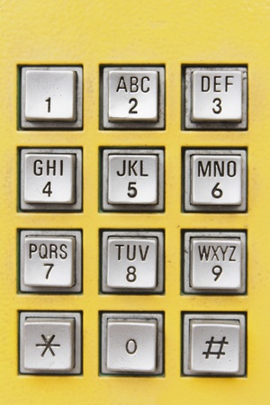 Buttons on yellow public telephone in Thailandの写真素材