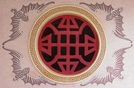 Decorative window opening on a Chinese temple in Thailandの写真素材
