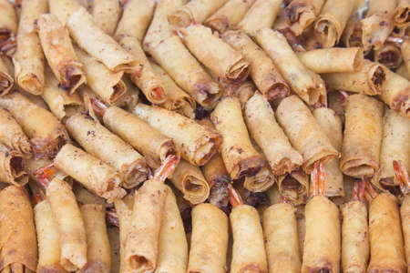 Background of deep fried spring rolls stuffed with prawnsの写真素材