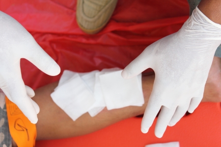 First aid by use cotton arrange on legの写真素材