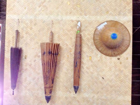 Old of wood umbrellas and hats hang on mat wallの素材