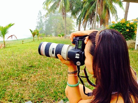 Thai woman take photo with Canon camera and lens 70-200mm f4