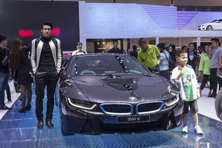 BANGKOK - APRIL 2: Unidentified male posts at the BMW i8 car on display at The 35th Bangkok International Motor Show on April 2, 2014 in Bangkok, Thailand.のeditorial素材