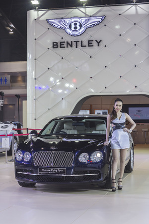 BANGKOK - APRIL 2: Unidentified lady posts at the Bentley The new Flying Spur car on display at The 35th Bangkok International Motor Show on April 2, 2014 in Bangkok, Thailand.のeditorial素材
