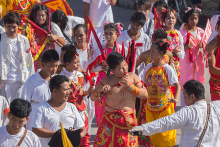 NAKHON SI THAMMARAT, THAILAND - OCTOBER 25: Taoist devotees participate in a street procession of the Nakhon Si Thammarat vegetarian festival on October 25, 2014 in Nakhon Si Thammarat province, Thailand. The festival was celebrated to make merit and saveのeditorial素材