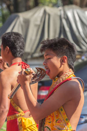 NAKHON SI THAMMARAT, THAILAND - OCTOBER 25: Taoist devotees participate in a street procession of the Nakhon Si Thammarat vegetarian festival on October 25, 2014 in Nakhon Si Thammarat province, Thailand. The festival was celebrated to make merit and saveのeditorial素材