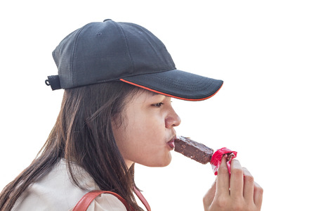 Closeup of beautiful Asian Thai woman eating ice cream isolated on white backgroundの写真素材