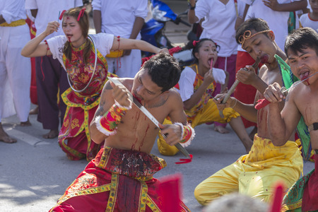 NAKHON SI THAMMARAT, THAILAND - OCTOBER 25: Taoist devotees participate in a street procession of the Nakhon Si Thammarat vegetarian festival on October 25, 2014 in Nakhon Si Thammarat province, Thailand. The festival was celebrated to make merit and saveのeditorial素材