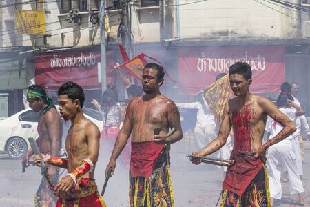 NAKHON SI THAMMARAT, THAILAND - OCTOBER 25: Taoist devotees participate in a street procession of the Nakhon Si Thammarat vegetarian festival on October 25, 2014 in Nakhon Si Thammarat province, Thailand. The festival was celebrated to make merit and saveのeditorial素材