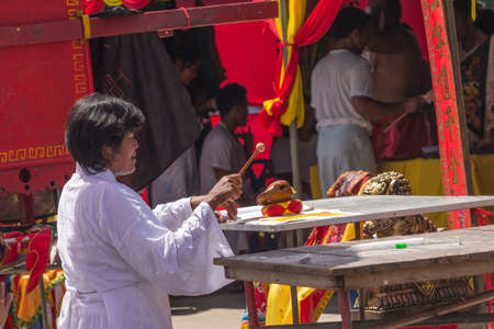 NAKHON SI THAMMARAT, THAILAND - OCTOBER 25: Taoist devotees participate in procession of the Nakhon Si Thammarat vegetarian festival on October 25, 2014 in Nakhon Si Thammarat province, Thailand. The festival was celebrated to make merit and save animals のeditorial素材