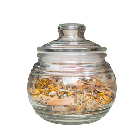 Orange peel in glass jar isolated on white background with clipping pathの写真素材