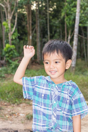 Cute outdoor portrait of happy smiling Asian Thai little boy