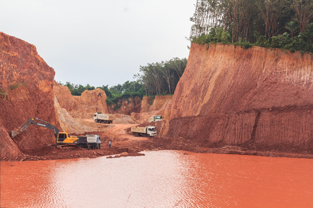 SURAT THANI, THAILAND - DECEMBER 20: Excavator digging underground and loading dumper truck December...