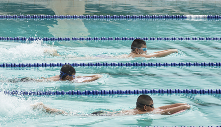 NAKHON SI THAMMARAT, THAILAND - JANUARY 16: Unidentified young boys in goggles and cap swimming race...