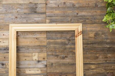 Big wooden picture frame near wall backgroundの写真素材