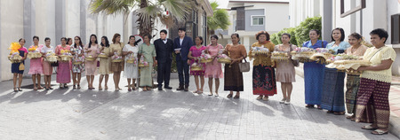 SONGKHLA, THAILAND - AUGUST 18: Procession of the groom's parents take group picture at Bride's house before giving present to bride in wedding ceremony day on August 18, 2016 in Songkhla, Thailand.のeditorial素材