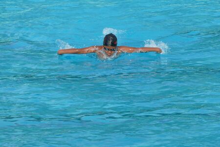 NAKHON SI THAMMARAT, THAILAND - APRIL 29: Asian Thai young boy in the swimming pool at the leisure center on April 29, 2016 in Nakhon Si Thammarat, Thailand.のeditorial素材