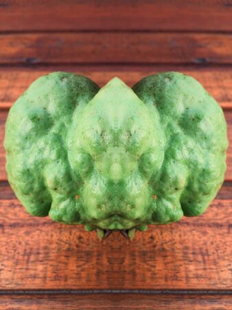 Green guava fruit on wood background