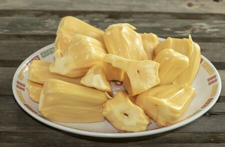Fresh sweet jackfruit segment on dish plate ready for eat over wooden table