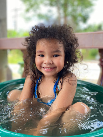 Portrait of a cute little girl having fun in a hot tubの写真素材