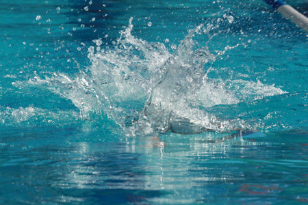 Swimming competition in the swimming pool, close up of water splashesの写真素材