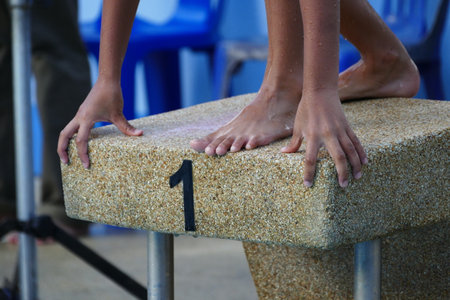 Athlete on the starting block of the swimming pool, competitionの写真素材