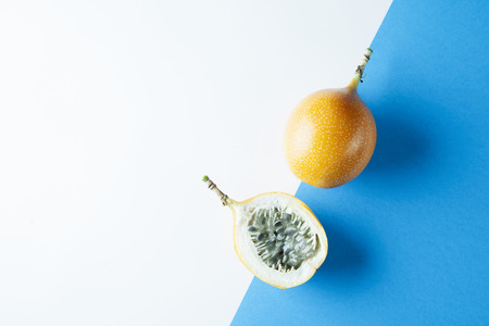 Passion fruit on blue white background, fresh summerの写真素材